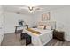 Bright primary bedroom with hardwood flooring, ceiling fan, and modern furniture and decorations at 1271 Old Mill Rd, Orlando, FL 32806