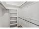 Organized walk-in closet featuring built-in shelving and a wire rack for efficient storage solutions at 1271 Old Mill Rd, Orlando, FL 32806