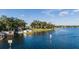 Scenic waterfront home with a private dock, boathouse, and lush landscaping at 1271 Old Mill Rd, Orlando, FL 32806