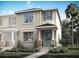Charming two-story home featuring a quaint porch, stone accents, manicured landscaping, and a refreshing teal front door at 1315 Tarflower Dr, Winter Springs, FL 32708