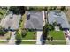 Aerial view of home with solar panels, screened-in pool, manicured lawn and lush landscaping at 13631 Via Roma Cir, Clermont, FL 34711