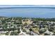 Expansive aerial view showcases the serene lakefront community surrounded by lush greenery at 13631 Via Roma Cir, Clermont, FL 34711