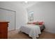 Cozy bedroom with plush carpeting, neutral walls, and a comfortable bed with decorative pillows at 13631 Via Roma Cir, Clermont, FL 34711