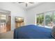 Bedroom featuring a private patio, wood floors, and natural light at 13631 Via Roma Cir, Clermont, FL 34711