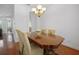 Elegant dining room featuring a wood table under a chandelier, ideal for Gathering meals and entertaining at 13631 Via Roma Cir, Clermont, FL 34711
