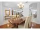 Bright dining room with a wooden table, chandelier, and built-in shelving, perfect for Gathering gatherings at 13631 Via Roma Cir, Clermont, FL 34711
