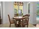 Dining area with decorative lighting, round table, and views of outdoor pool area at 13631 Via Roma Cir, Clermont, FL 34711