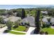 A well-maintained home featuring a lush lawn and mature landscaping, nestled near a tranquil lake at 13631 Via Roma Cir, Clermont, FL 34711