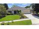 Charming single-story home with a well-manicured lawn and beautiful landscaping at 13631 Via Roma Cir, Clermont, FL 34711