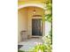 Welcoming front porch featuring a classic entry door, sidelight window and a cozy bench at 13631 Via Roma Cir, Clermont, FL 34711