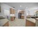 Open kitchen with stainless appliances, light wood cabinets, and neutral countertops at 13631 Via Roma Cir, Clermont, FL 34711