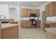 Bright kitchen with wood cabinets, stainless steel appliances, and ample counter space for cooking at 13631 Via Roma Cir, Clermont, FL 34711