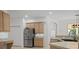 Kitchen with stainless steel refrigerator, light wood cabinets and large sink at 13631 Via Roma Cir, Clermont, FL 34711