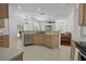 Kitchen view with center island, stainless steel dishwasher, and open floor plan at 13631 Via Roma Cir, Clermont, FL 34711