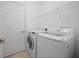 Efficient laundry room featuring a modern washer and dryer with ample shelving and clean, white walls at 13631 Via Roma Cir, Clermont, FL 34711