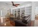Inviting living room with custom built-ins, providing ample storage and display space, and comfortable furnishings at 13631 Via Roma Cir, Clermont, FL 34711