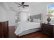 Comfortable main bedroom featuring a gray bed frame, hardwood floors, and natural light at 13631 Via Roma Cir, Clermont, FL 34711