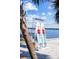 Paddle board rental stand on a white sand beach and calm lake waters and sunny skies at 13631 Via Roma Cir, Clermont, FL 34711