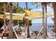Picturesque outdoor lakefront patio featuring picnic tables and shade canopies at 13631 Via Roma Cir, Clermont, FL 34711