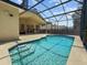 Beautiful screened-in pool featuring a relaxing spot with clear blue water and seamless patio at 13631 Via Roma Cir, Clermont, FL 34711
