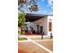 Outdoor seating area at modern restaurant with brick flooring, awnings, and black metal accents at 13631 Via Roma Cir, Clermont, FL 34711