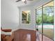 Cozy room with lots of natural light, views of the pool, wood flooring and comfortable seating at 13631 Via Roma Cir, Clermont, FL 34711
