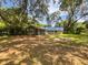 Secluded backyard featuring a screened lanai and lush, mature trees surrounding the home at 13794 Sw 112Th St, Dunnellon, FL 34432
