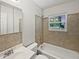 Neutral-toned bathroom featuring a tub/shower combination and a vanity with storage at 13794 Sw 112Th St, Dunnellon, FL 34432