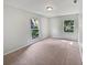 Bright bedroom with neutral carpet and two windows offering natural light at 13794 Sw 112Th St, Dunnellon, FL 34432