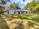 Charming single-story home featuring a new blue metal roof and verdant lawn at 13794 Sw 112Th St, Dunnellon, FL 34432