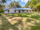 Charming single-story home featuring a new blue metal roof and verdant lawn at 13794 Sw 112Th St, Dunnellon, FL 34432