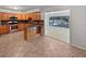 Open-concept kitchen flowing into a sunroom with stainless steel appliances and ample cabinetry at 13794 Sw 112Th St, Dunnellon, FL 34432