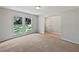 Bright living room features neutral carpet and fresh paint, perfect for relaxation at 13794 Sw 112Th St, Dunnellon, FL 34432
