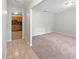 Bright living room featuring neutral carpet and a view into the adjacent kitchen at 13794 Sw 112Th St, Dunnellon, FL 34432