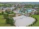 A scenic aerial view showcases a large community pool, volleyball court and recreational area with multiple amenities at 1478 Moon Valley Dr, Davenport, FL 33896