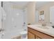 Bright bathroom featuring a tub-shower combo with white tile, a vanity with countertop space, and a toilet at 1478 Moon Valley Dr, Davenport, FL 33896