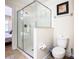 Bright bathroom boasts a glass-enclosed shower, toilet, and access to an adjacent bedroom at 1478 Moon Valley Dr, Davenport, FL 33896