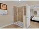Tiled bathroom featuring a glass-enclosed shower with a bench at 1478 Moon Valley Dr, Davenport, FL 33896