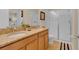 Bright bathroom featuring double vanity with granite countertop and a glass-enclosed shower at 1478 Moon Valley Dr, Davenport, FL 33896