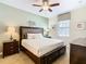 Comfortable bedroom features a padded headboard, soft carpet, and a window with a patterned shade at 1478 Moon Valley Dr, Davenport, FL 33896