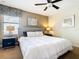 Relaxing bedroom features a grey upholstered headboard, ample lighting, and a large window at 1478 Moon Valley Dr, Davenport, FL 33896