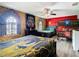 A bedroom features a queen bed, bunk bed, ceiling fan and Harry Potter themed decor at 1478 Moon Valley Dr, Davenport, FL 33896
