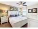Cozy bedroom featuring a white bed frame, soft grey pillows, and tasteful botanical wall art at 1478 Moon Valley Dr, Davenport, FL 33896