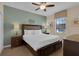 Cozy bedroom with a queen-sized bed, soft carpet, and a ceiling fan at 1478 Moon Valley Dr, Davenport, FL 33896