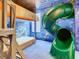 Unique bedroom featuring a bunk bed with an attached winding green slide for added fun at 1478 Moon Valley Dr, Davenport, FL 33896