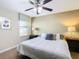 Well-lit bedroom features a comfortable queen-size bed, lamps, and neutral color palette at 1478 Moon Valley Dr, Davenport, FL 33896
