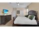 Bedroom with plush bed, dresser, and a side table next to the bed at 1478 Moon Valley Dr, Davenport, FL 33896