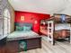 Themed bedroom featuring a full bed and bunk beds with playful decor and colors at 1478 Moon Valley Dr, Davenport, FL 33896