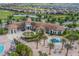 Aerial view showcases the spacious clubhouse, green space and pool with playground for the community at 1478 Moon Valley Dr, Davenport, FL 33896