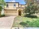 Charming two-story home with manicured lawn, a two-car garage, and inviting front entry at 1478 Moon Valley Dr, Davenport, FL 33896